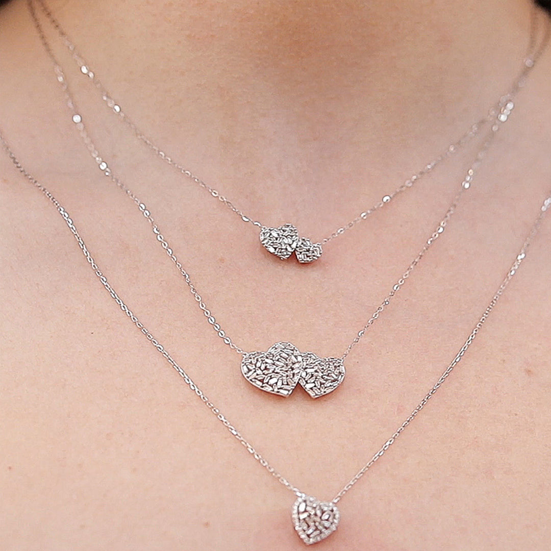 An elegant necklace with a delicate chain and a sparkling pendant, displayed on a neutral background to highlight its intricate design and fine craftsmanship.