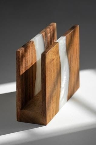 A sleek and stylish tissue holder made of materials like metal, wood, or acrylic, elegantly holding a box of tissues. The holder is designed to complement various decor styles while keeping tissues accessible and neatly organized.