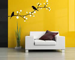 An array of wall art pieces, including framed prints, abstract paintings, and decorative wall decals, displayed in a modern interior setting, showcasing diverse styles and colors to enhance any room decor.