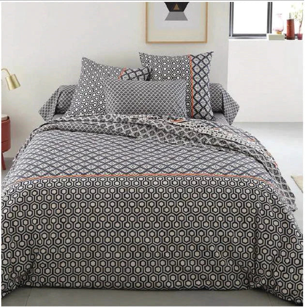 A set of duvet covers featuring various patterns and colors, neatly arranged on a bed. The covers include designs such as floral prints, geometric patterns, and solid colors, adding a stylish and cozy touch to the bedding.