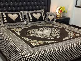 Printed bed sheets with vibrant patterns, such as floral, geometric, or abstract designs, spread neatly over a bed.