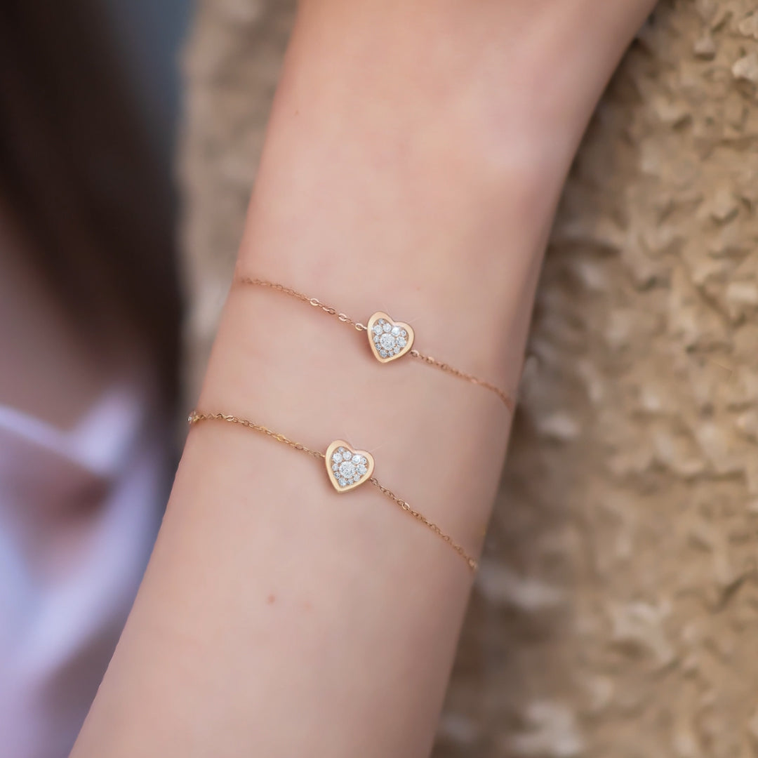 A pair of stylish earrings featuring a detailed design, including a combination of gemstones or pearls set in a metal framework, displayed against a soft background to emphasize their elegance and craftsmanship.