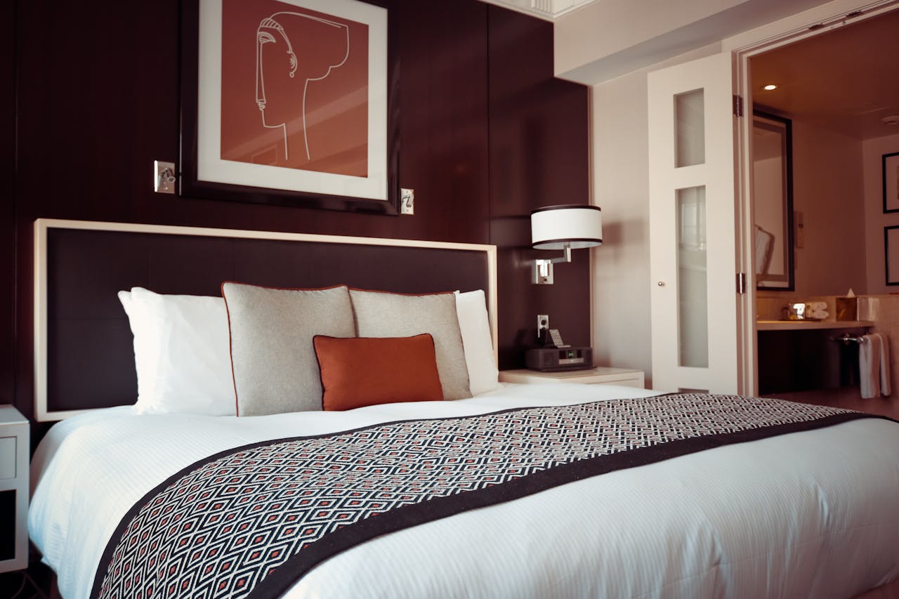 Freshly laundered bed sheets spread smoothly over a bed, featuring a crisp and clean appearance with a subtle pattern or solid color. The sheets are neatly arranged to highlight their soft texture and elegant design.