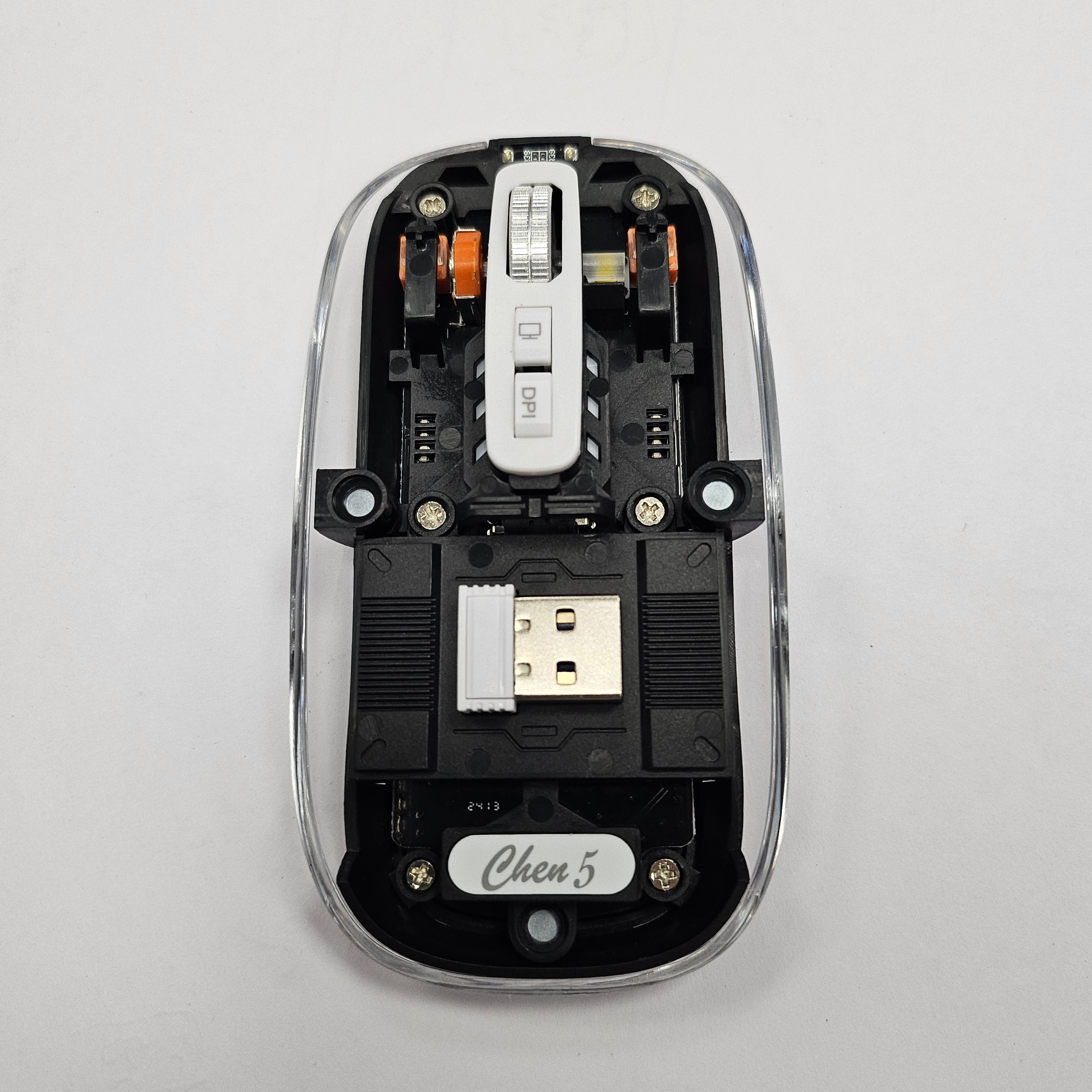 Clear, transparent computer mouse with sleek, minimalist design and ergonomic shape, ideal for modern workspaces.